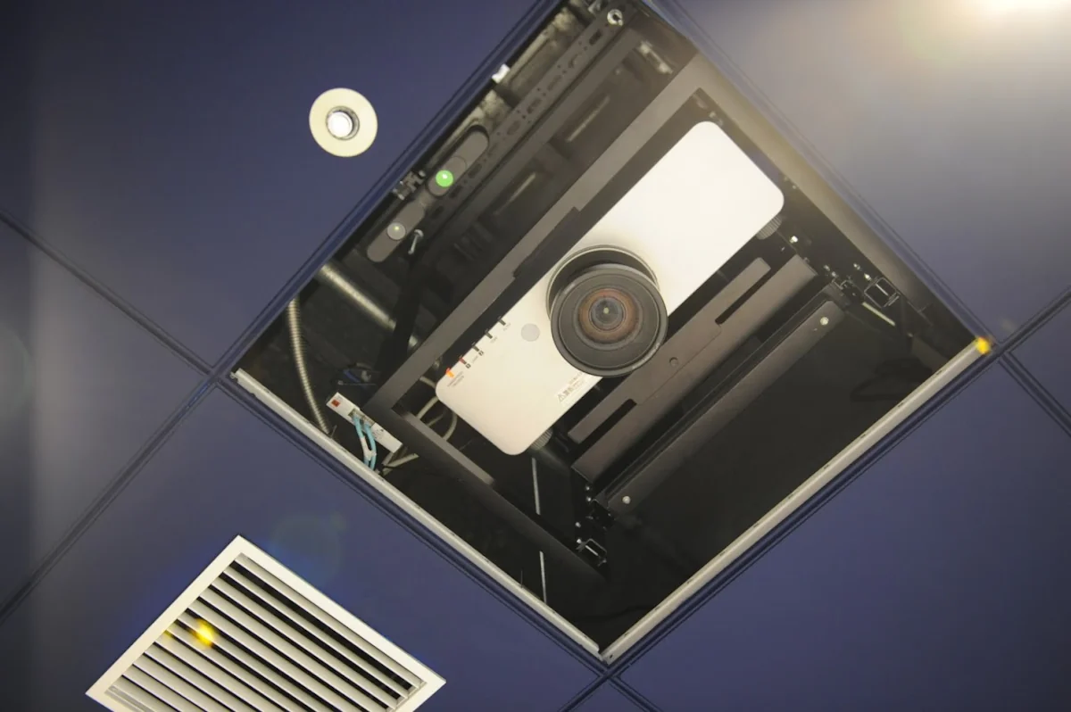Projector mounted in ceiling tile